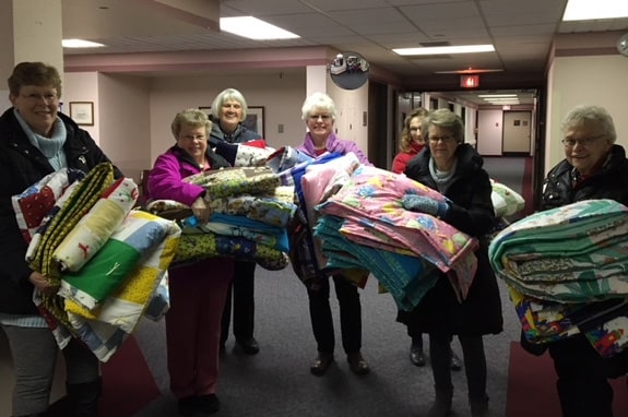 St. Paul's Lutheran Church - Mary/Martha quilters group with quilts